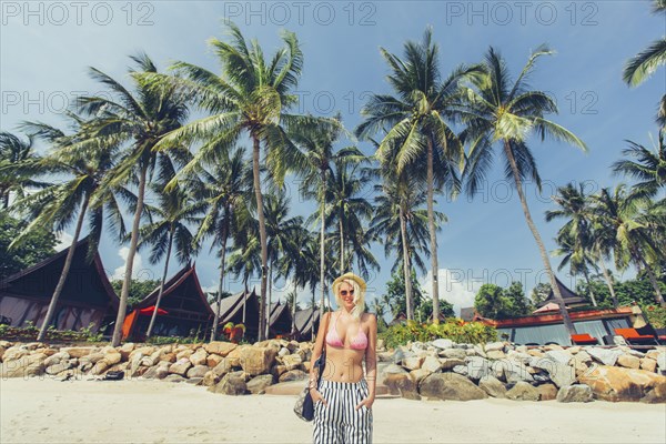 Caucasian woman walking on beach