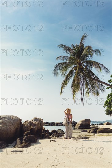 Caucasian woman walking on beach