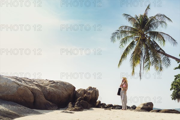 Caucasian woman standing on beach