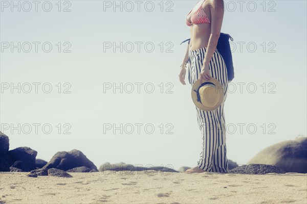 Caucasian woman standing on beach