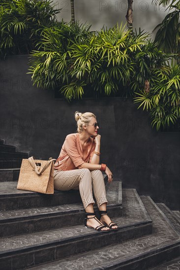 Caucasian woman sitting on stairs