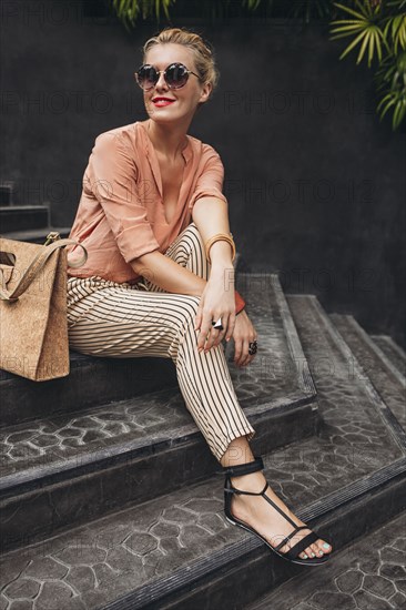 Caucasian woman sitting on stairs