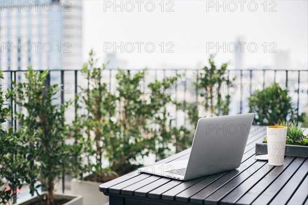 Laptop on balcony table