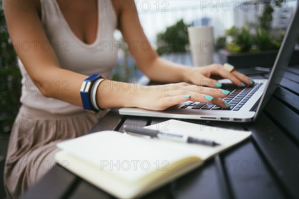 Caucasian woman using laptop outdoors