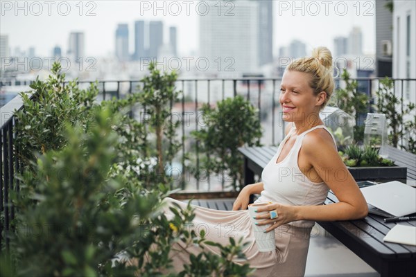 Caucasian woman sitting on balcony