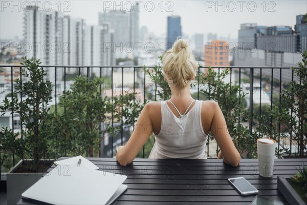 Caucasian woman sitting on balcony