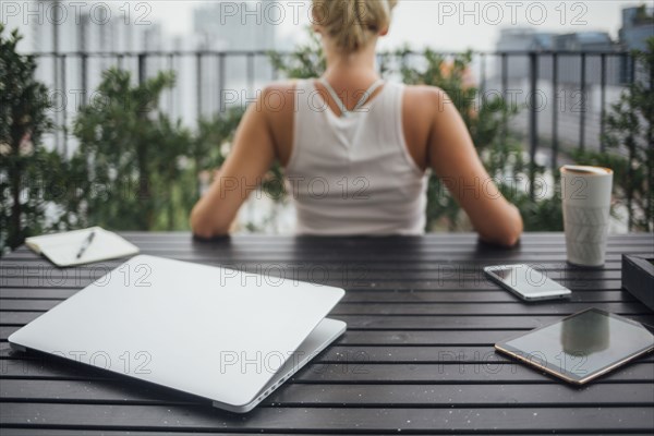 Caucasian woman sitting on balcony