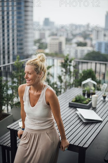 Caucasian woman standing on balcony