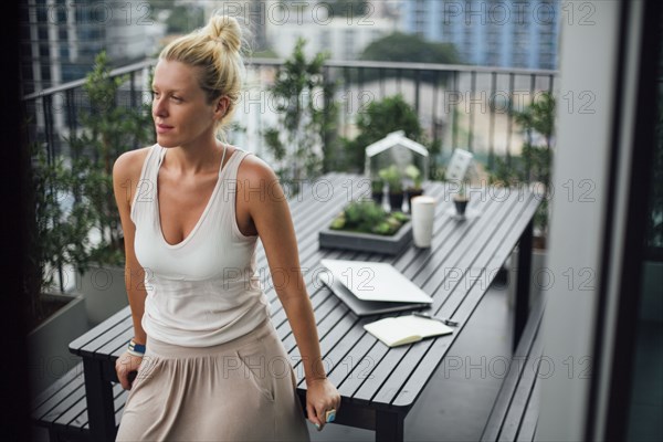 Caucasian woman standing on balcony