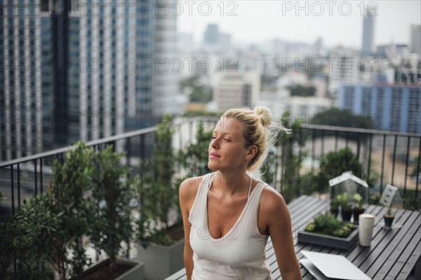 Caucasian woman standing on balcony