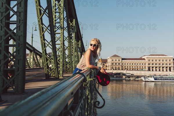 Caucasian woman standing on bridge