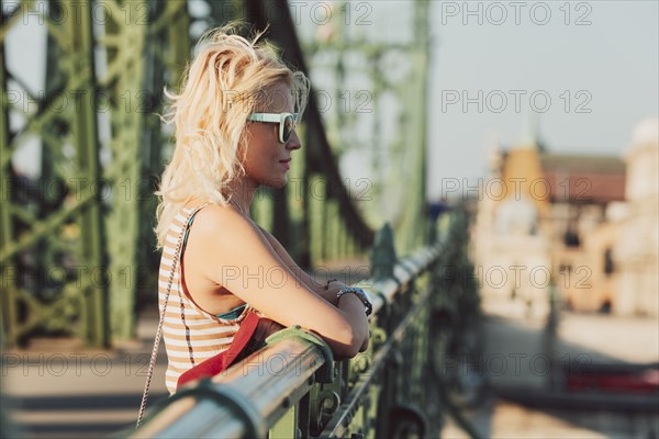 Caucasian woman standing on bridge