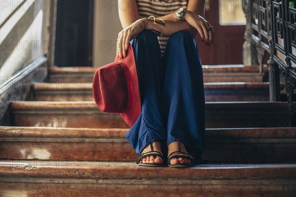 Caucasian woman sitting on stairs