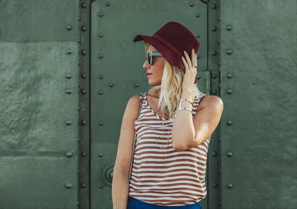 Caucasian woman in hat and sunglasses