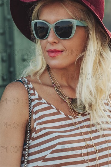 Caucasian woman in hat and sunglasses