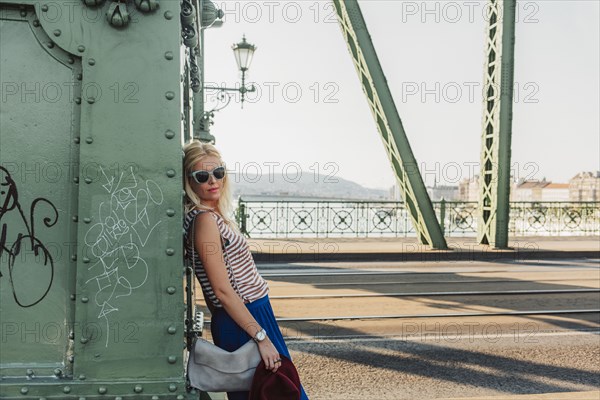 Caucasian woman standing on bridge