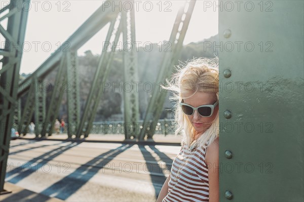 Caucasian woman standing on bridge