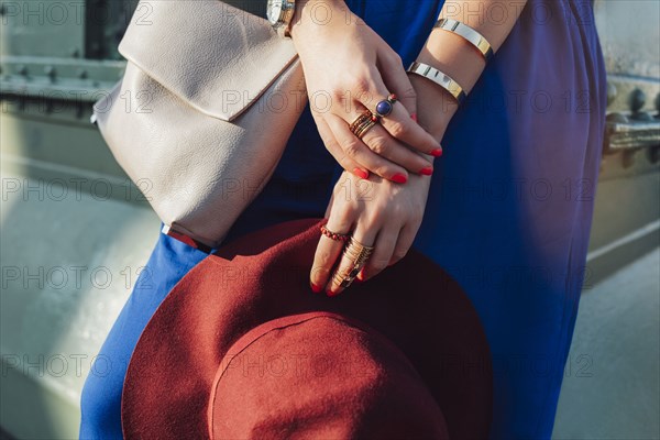 Caucasian woman holding hat and purse