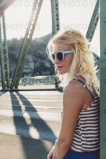 Caucasian woman standing on bridge