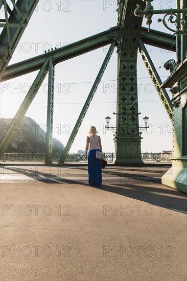 Caucasian woman standing on bridge