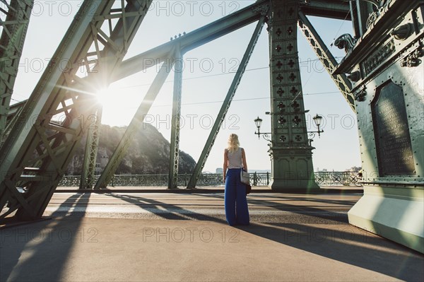 Caucasian woman standing on bridge