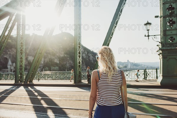 Caucasian woman standing on bridge