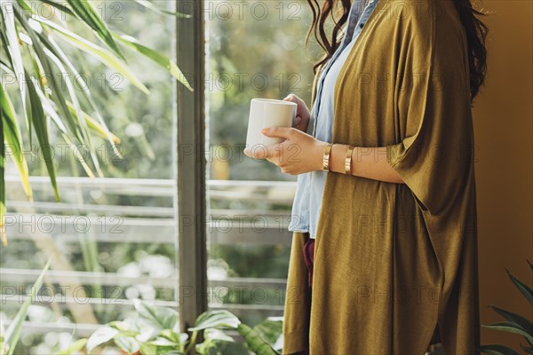 Caucasian woman drinking cup of coffee