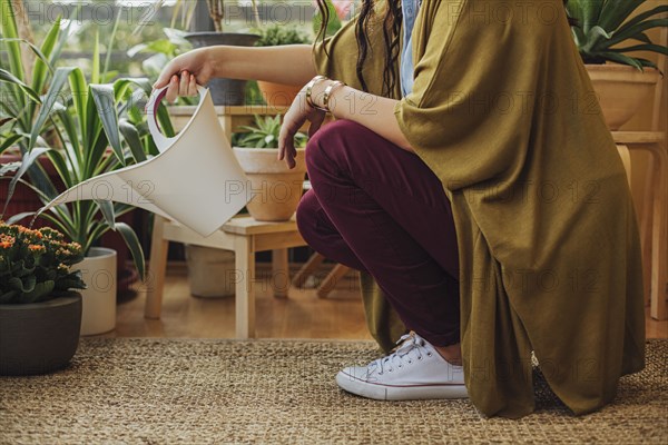 Caucasian woman watering potted plants