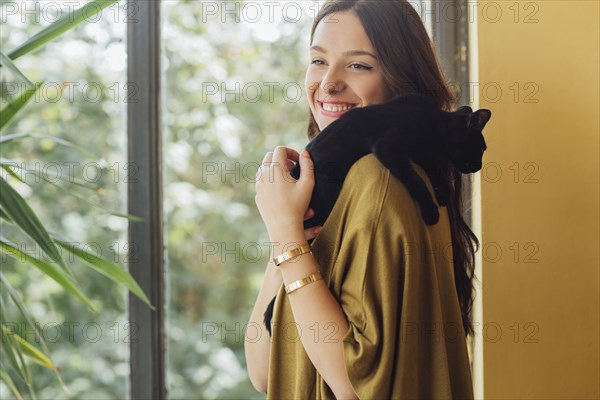 Caucasian woman holding kitten