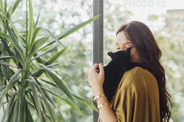 Caucasian woman holding kitten