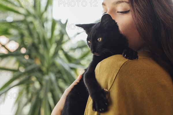 Caucasian woman holding kitten