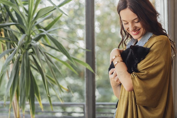 Caucasian woman holding kitten