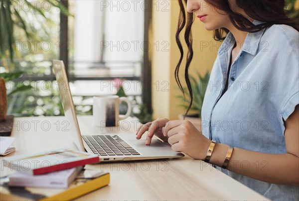 Caucasian woman using laptop at desk