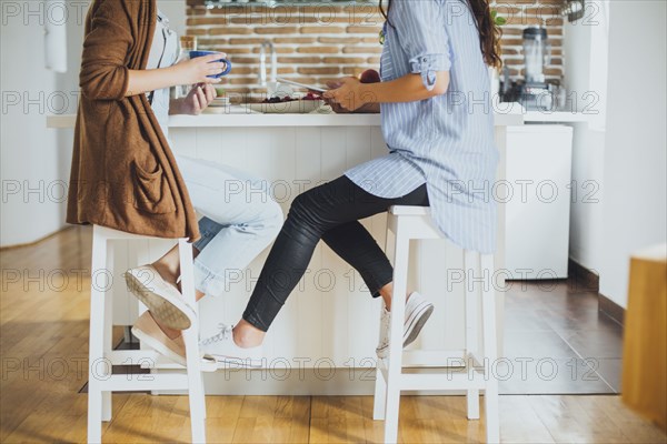 Caucasian women sitting at counter