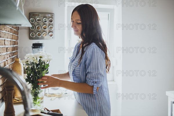 Caucasian woman arranging flowers