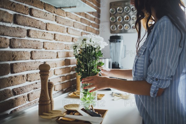 Caucasian woman arranging flowers