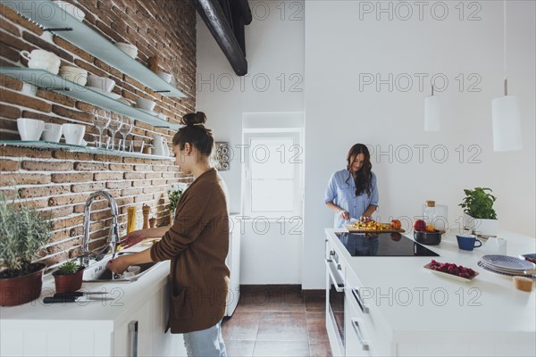 Caucasian women cooking in kitchen