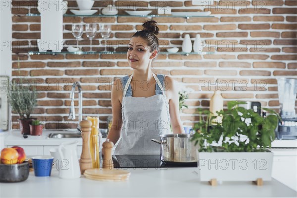 Caucasian woman cooking in kitchen