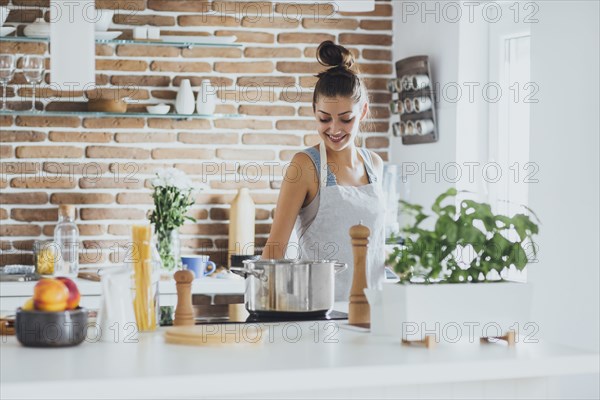 Caucasian woman cooking in kitchen