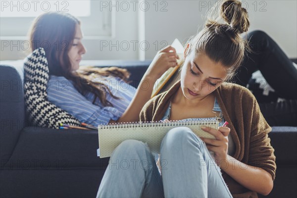 Caucasian women studying in living room