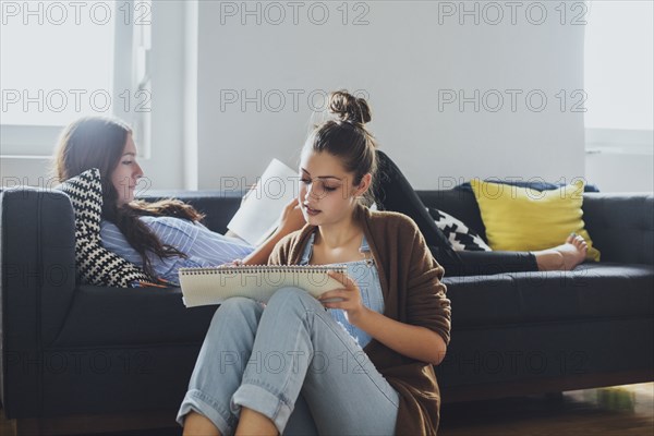 Caucasian women studying in living room