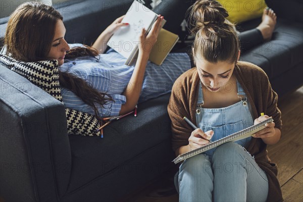 Caucasian women studying in living room