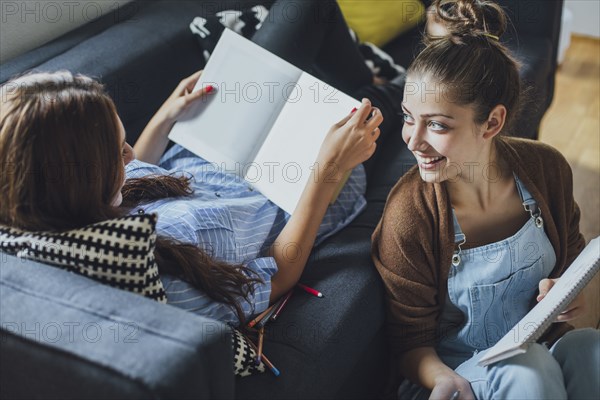 Caucasian women studying in living room