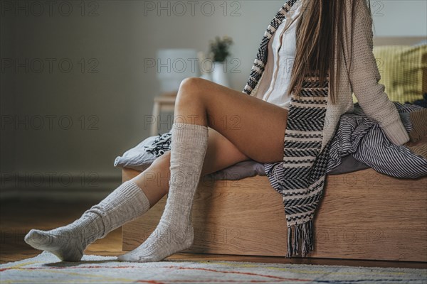 Caucasian woman sitting on bed