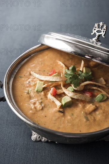 Tortilla soup in silver pot