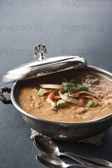 Tortilla soup in silver pot