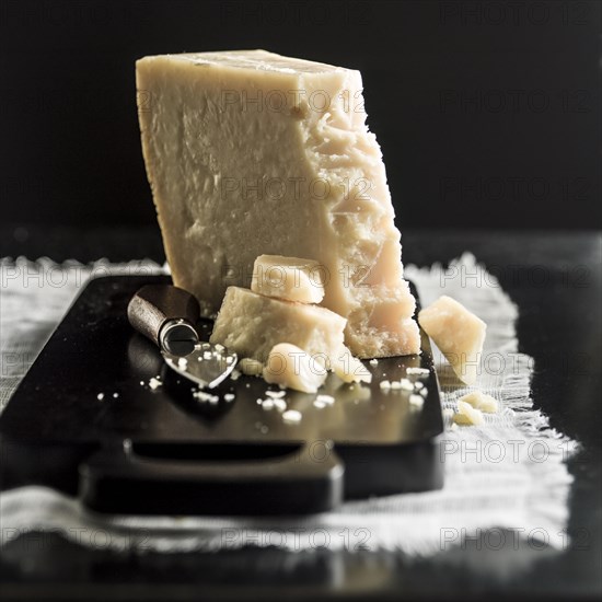 Parmesan cheese crumbles on cutting board