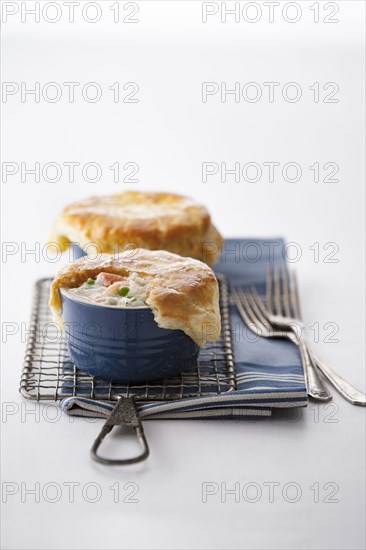 Seafood pot pies and forks on rack