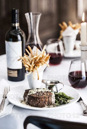 Gourmet pepper steak with french fries and red wine