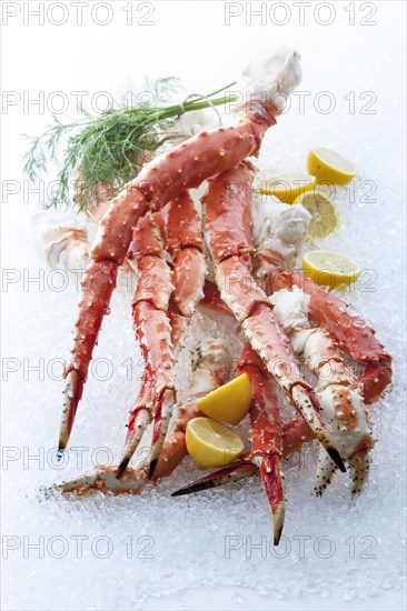 Crab legs and lemons on ice